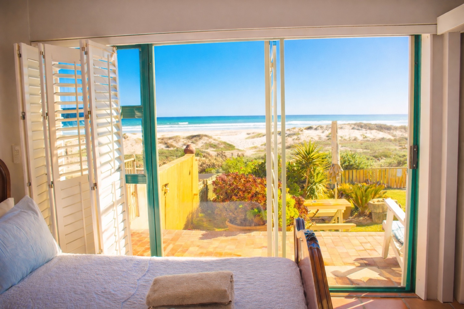 Beach-facing guest room with dune and ocean view in Melkbosstrand